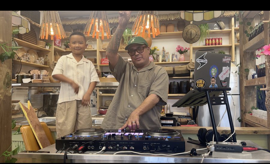 Hedspin on turntables with Ollie dancing beside him